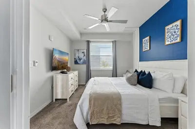 a bedroom with a bed and a ceiling fan at Spacious 2BR Mickey Bedroom Lake View in Kissimmee