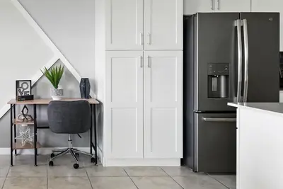 a kitchen with a desk and a refrigerator at Spacious 2BR Mickey Bedroom Lake View in Kissimmee