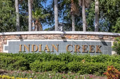a sign for indian creek with palm trees in the background at Magical Family Getaway - 10ppl in Kissimmee