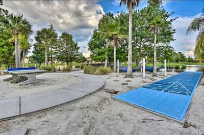 a playground with a picnic table and a blue mat at Palm Tree in Paradise - 10ppl in Kissimmee