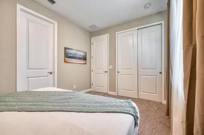 a bedroom with two white doors and a bed at Villa 4 Quartos c/ Piscina Perto da Disney + Temas in Orlando