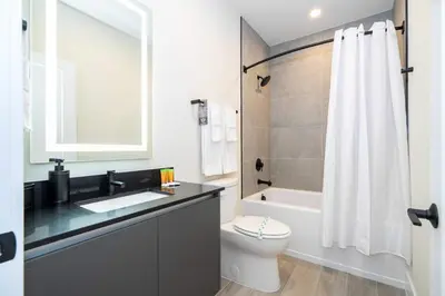 a bathroom with a sink and a toilet and a bath tub at Modern 3Bd Screened Pool at Serenity Resort 17322 in Orlando