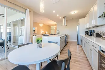 a kitchen with a white table and chairs at Windsor Hills 4Q c Piscina + Game Room Mario in Orlando
