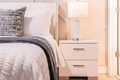 a bedroom with a bed with a white bedside table at Windsor Hills 4Q c Piscina + Game Room Mario in Orlando