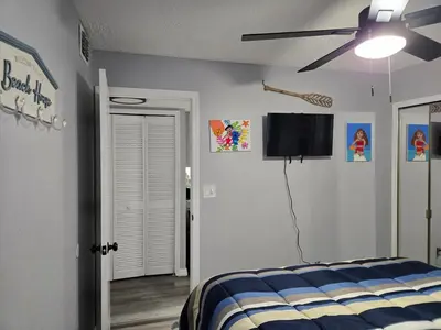 a bedroom with a bed and a flat screen tv at Great condo getaway! in Kissimmee