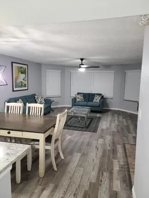 a living room with a table and a couch at Great condo getaway! in Kissimmee