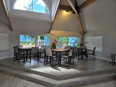 a dining room with tables and chairs and a window at Great condo getaway! in Kissimmee