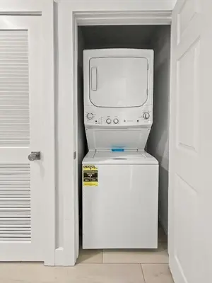 a television sitting on top of a white refrigerator at Modern & Spacious 3 Bedroom Retreat! in Orlando