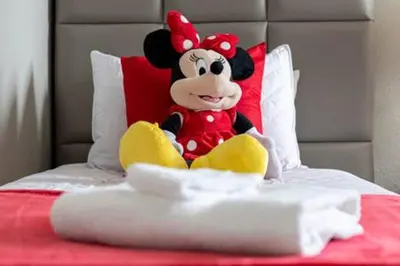 a stuffed mickey mouse sitting on top of a bed at ECR641 8B Stunning Dream Vacation @Encore in Orlando