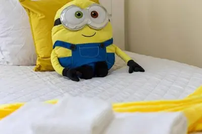 a stuffed minion is sitting on a bed at ECR641 8B Stunning Dream Vacation @Encore in Orlando