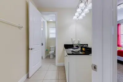 a white kitchen with a sink and a bathroom at ECR641 8B Stunning Dream Vacation @Encore in Orlando