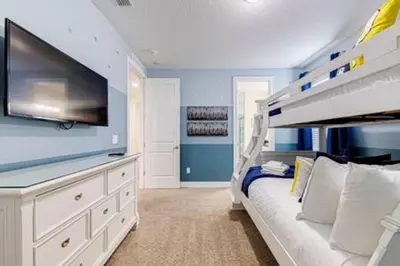 a bedroom with a white bunk bed and a tv at ECR641 8B Stunning Dream Vacation @Encore in Orlando