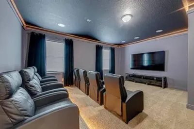 a room with a bunch of chairs and a flat screen tv at ECR641 8B Stunning Dream Vacation @Encore in Orlando