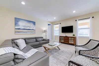 a living room with a couch and a tv at ECR641 8B Stunning Dream Vacation @Encore in Orlando