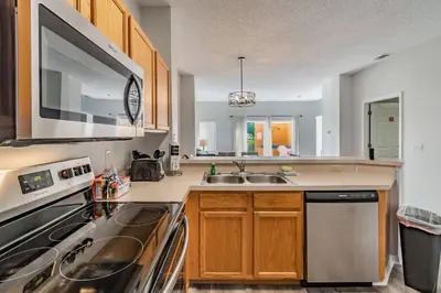 a kitchen with a sink and a stove at Private Hot Tub near Disney Parks in Kissimmee