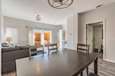 a dining room and living room with a table and chairs at Private Hot Tub near Disney Parks in Kissimmee