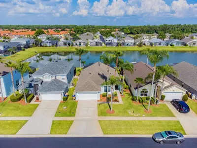 an aerial view of a residential neighborhood with houses and a lake at Private Heated Pool near Disney in Kissimmee