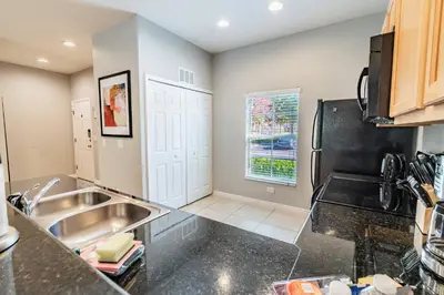 a kitchen with a sink and a refrigerator at 15min to Disney · Modern Home Hot Tub in Kissimmee