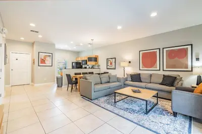 a living room with a couch and a table at 15min to Disney · Modern Home Hot Tub in Kissimmee