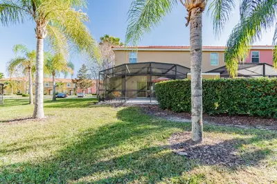 a house with palm trees in front of it at 15min to Disney · Modern Home Hot Tub in Kissimmee