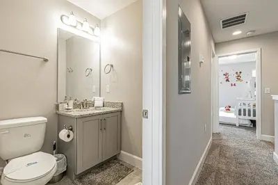 a bathroom with a toilet and a sink at Themed Bedrooms BBQ Near Disney in Kissimmee