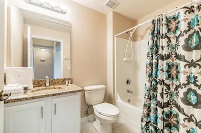 a bathroom with a toilet and a sink and a shower at Family Home Near Disney – Modern Bright in Kissimmee