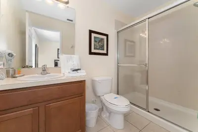 a bathroom with a toilet and a sink and a shower at Family Villa w Pool · 20min Disney in Kissimmee