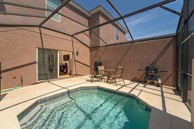 a swimming pool on a patio next to a building at Family Villa w Pool · 20min Disney in Kissimmee
