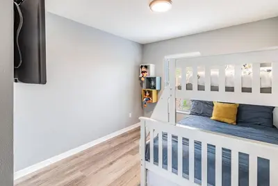a childs room with a white bunk bed at Family Townhome Near Disney w Heated Pool in Kissimmee