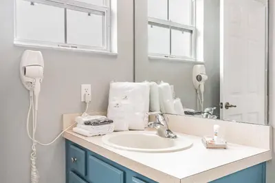 a bathroom with a sink and a mirror at Family Townhome Near Disney w Heated Pool in Kissimmee