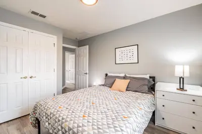 a bedroom with a bed and a white dresser at Family Townhome Near Disney w Heated Pool in Kissimmee