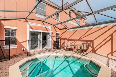 a swimming pool in a building with a house at Family Townhome Near Disney w Heated Pool in Kissimmee