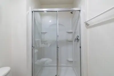 a shower with a glass door in a bathroom at 3BR Townhome Near Disney Free Jacuzzi in Kissimmee