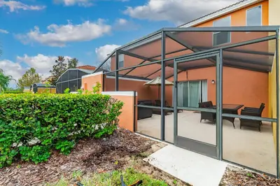a glass extension of a house with a patio at 3BR Townhome Near Disney Free Jacuzzi in Kissimmee