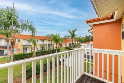 a balcony with a white fence and condos at Cozy 3BR Townhome Near Disney in Kissimmee in Kissimmee