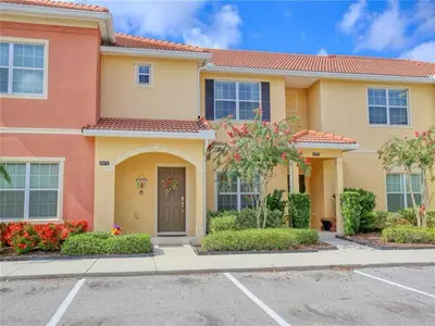a house with a driveway in front of it at Cozy 3BR Villa 15min from Disney Heated Pool in Kissimmee