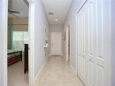a hallway with white walls and a white door at Cozy 3BR Villa 15min from Disney Heated Pool in Kissimmee