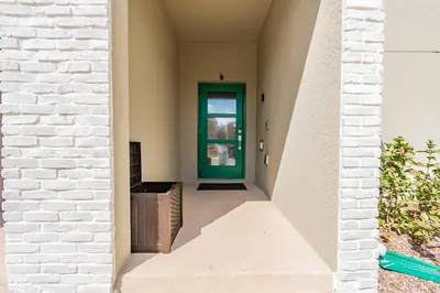a hallway with a green door in a house at Disney 15min - Private Pool BBQ in Kissimmee