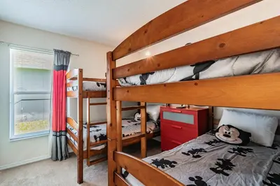 a bedroom with two bunk beds and a window at Lake Berkley Getaway – 5BR Resort Home in Kissimmee