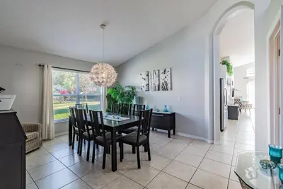 a dining room with a table and chairs at Lake Berkley Getaway – 5BR Resort Home in Kissimmee