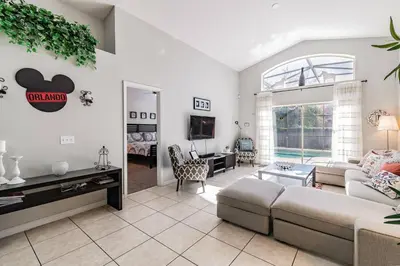 a living room with a couch and a table at Lake Berkley Getaway – 5BR Resort Home in Kissimmee