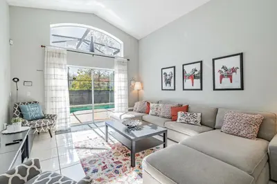 a living room with a couch and a table at Lake Berkley Getaway – 5BR Resort Home in Kissimmee