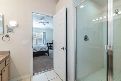 a bathroom with a shower with a glass door at Lake Berkley Getaway – 5BR Resort Home in Kissimmee