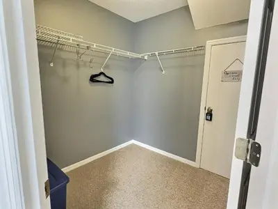 a walk in closet with a hanger in a room at Lake Berkley Getaway – 5BR Private Pool in Kissimmee
