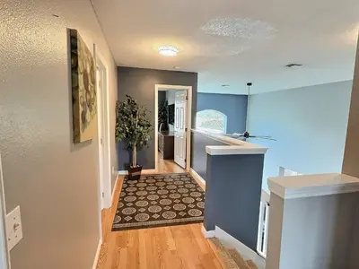 a hallway with blue walls and a hallway with a hallway at Lake Berkley Getaway – 5BR Private Pool in Kissimmee