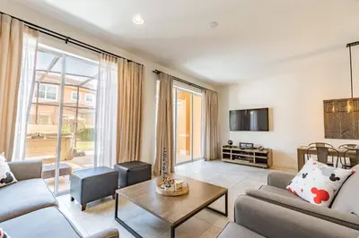 a living room with a couch and a table at 2BR Villa Near Disney Resort Amenities in Kissimmee