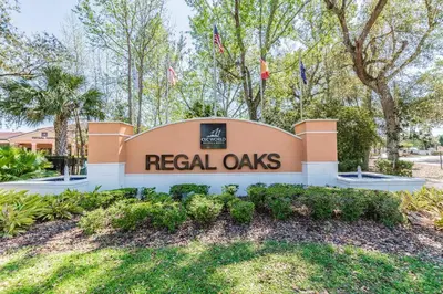 a sign that reads real oaks with trees in the background at 2BR Villa Near Disney Resort Amenities in Kissimmee