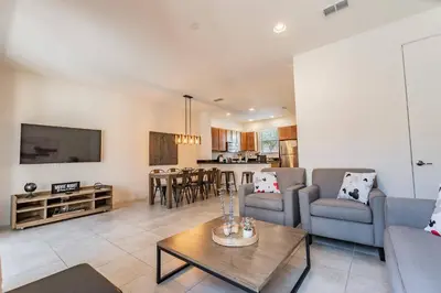 a living room with a couch and a table at 2BR Villa Near Disney Resort Amenities in Kissimmee