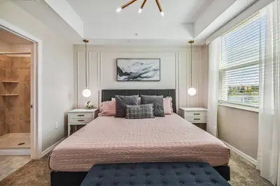 a bedroom with a large bed and two windows at Luxury Resort · Pool Lazy River in Kissimmee