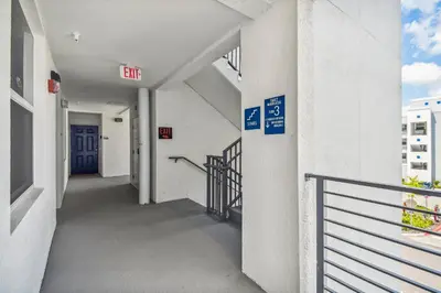 an empty hallway of a building with a blue door at Luxury Resort · Pool Lazy River in Kissimmee